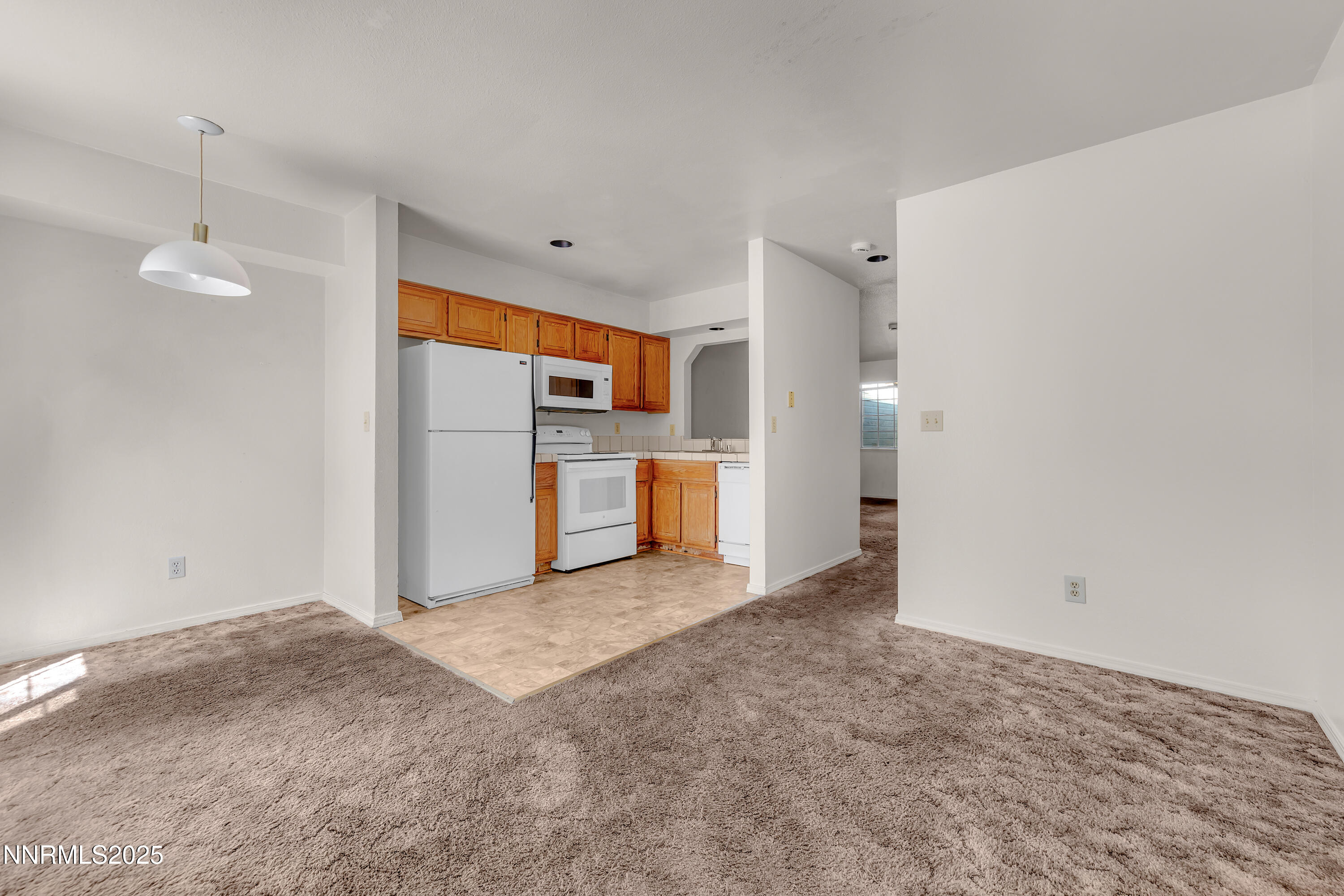 2650 Plumas Street, Unit 11 Reno, NV 89509 - Photo 9 of 33 a view of a kitchen with a sink and a refrigerator