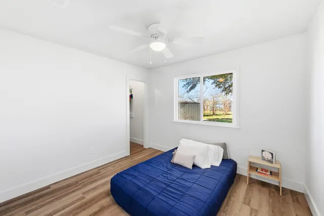 a living room with a bed and painting on the wall