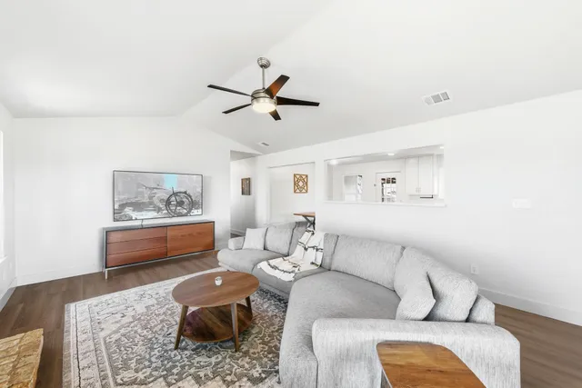a living room with furniture and a rug