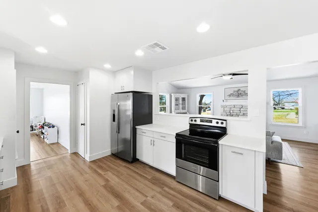 a kitchen with stainless steel appliances a refrigerator sink and stove