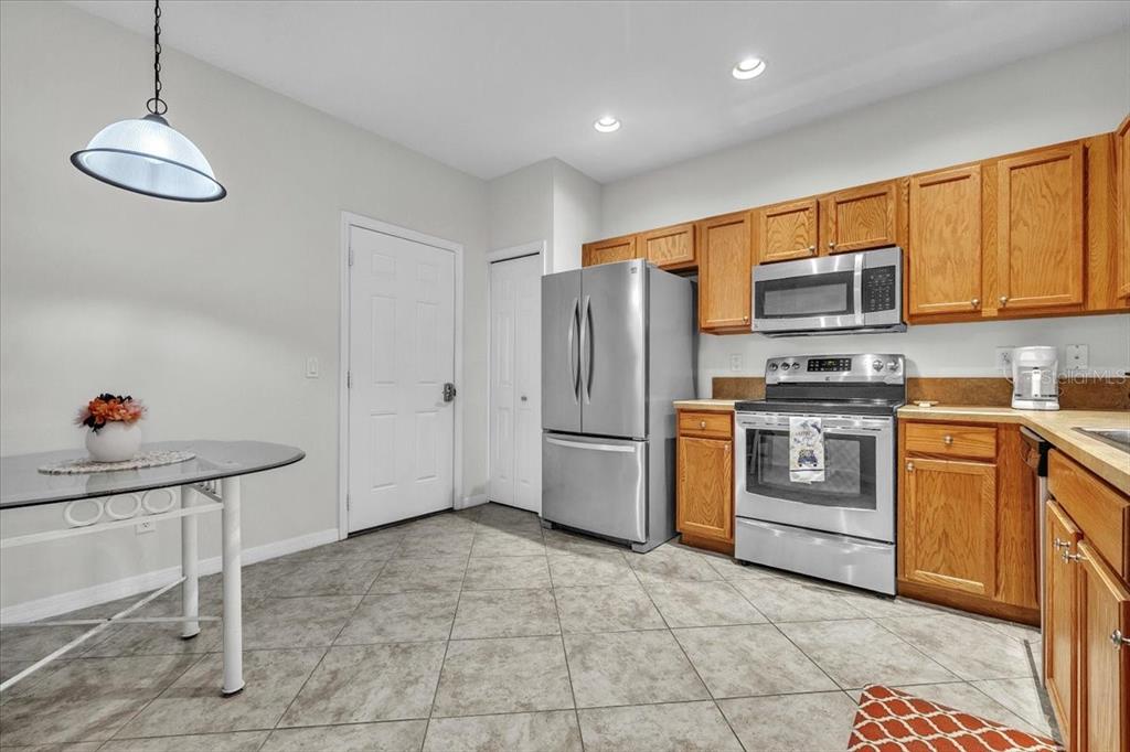 3954 Cherrybrook Loop Fort Myers, FL 33966 - Photo 14 of 47 a kitchen with stainless steel appliances a stove a sink and cabinets