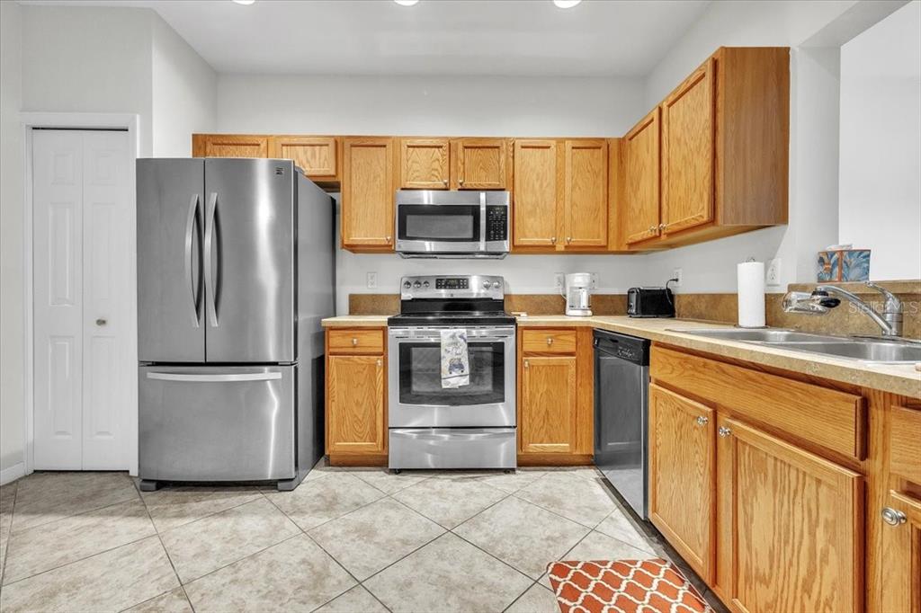 3954 Cherrybrook Loop Fort Myers, FL 33966 - Photo 15 of 47 a kitchen with stainless steel appliances granite countertop a refrigerator stove and sink