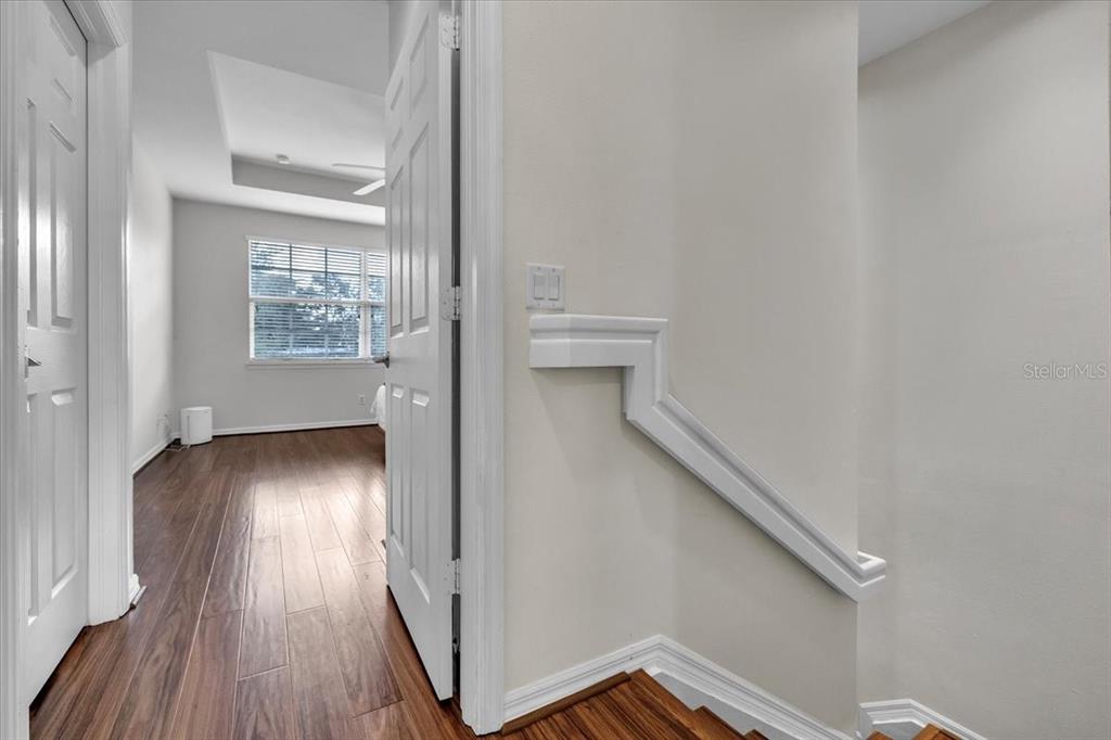 3954 Cherrybrook Loop Fort Myers, FL 33966 - Photo 22 of 47 a view of a hallway with wooden floor and staircase