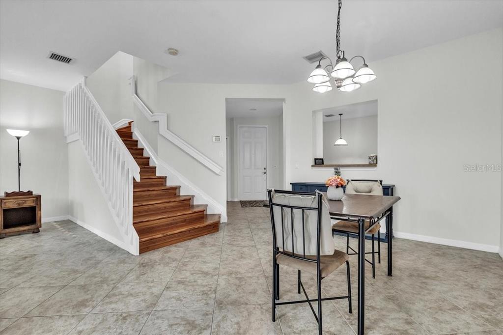 3954 Cherrybrook Loop Fort Myers, FL 33966 - Photo 3 of 47 a view of a dining room with furniture and a chandelier