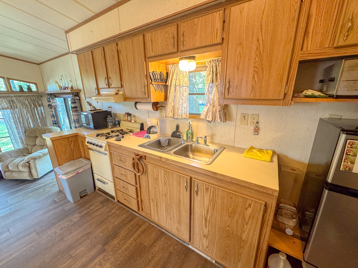 5-58 Woodhaven Sublette, IL 61367 - Photo 10 of 16 a room with stainless steel appliances a sink a window and cabinets