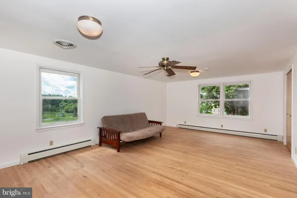 a living room with furniture and ceiling fan