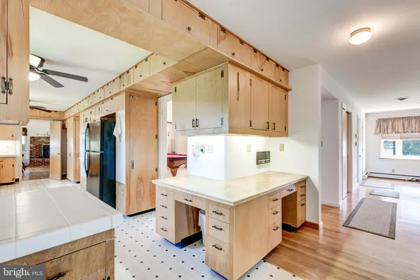 a kitchen with a sink a stove a refrigerator and white cabinets