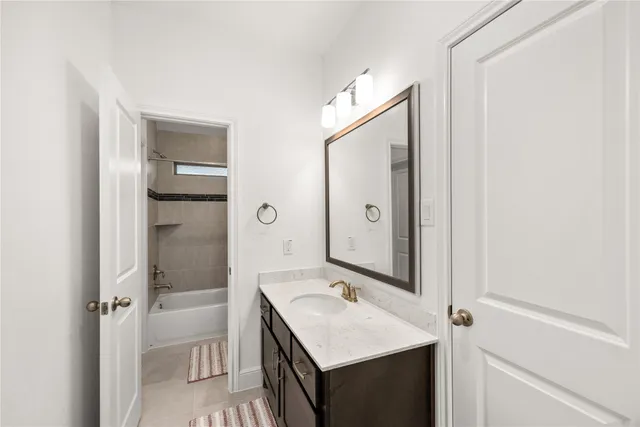 a bathroom with a sink a mirror and a shower