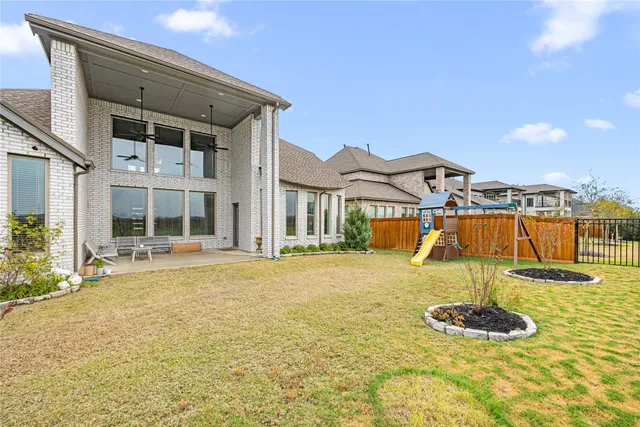 a backyard of a house with table and chairs