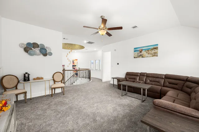 a living room with furniture a couch and a window