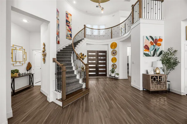 a view of an entryway with wooden floor and stairs