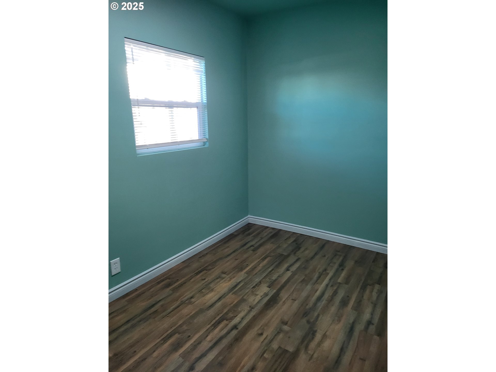 811 Laurel Avenue Reedsport, OR 97467 - Photo 21 of 34 a view of an empty room with wooden floor and a window
