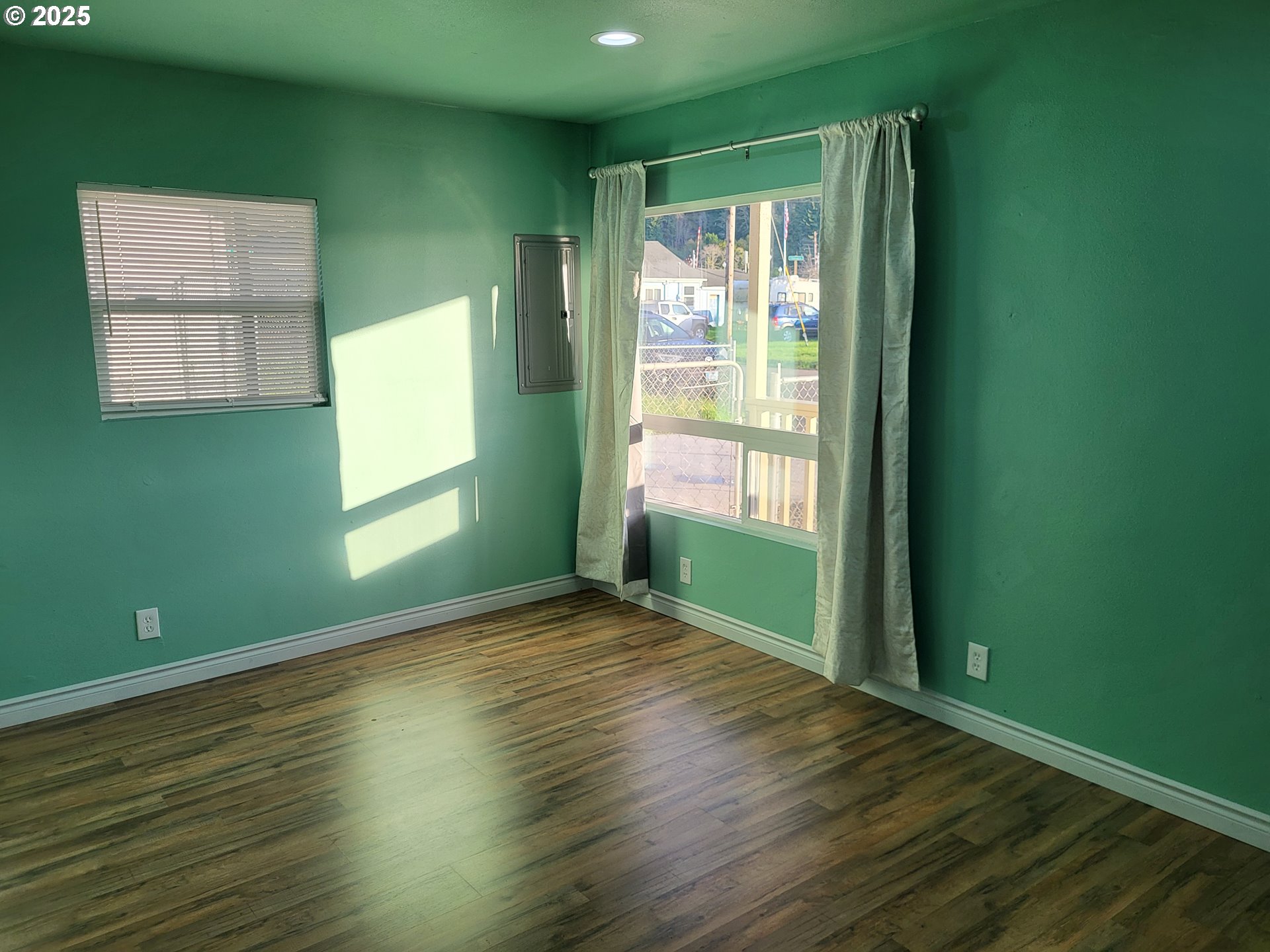 811 Laurel Avenue Reedsport, OR 97467 - Photo 3 of 34 a view of an empty room with wooden floor and a window