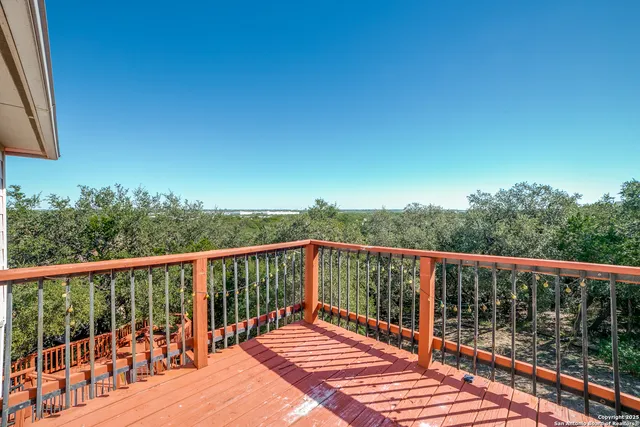 a balcony with wooden floor and fence