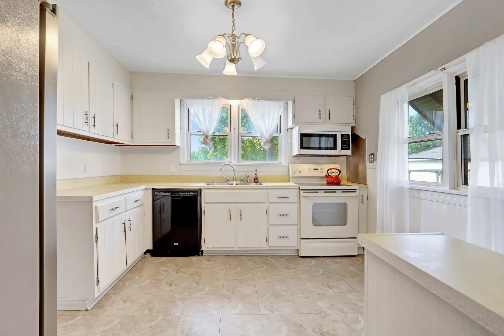 812 East Webster Street Clinton, IL 61727 - Photo 11 of 26 a open kitchen with granite countertop white cabinets and white appliances