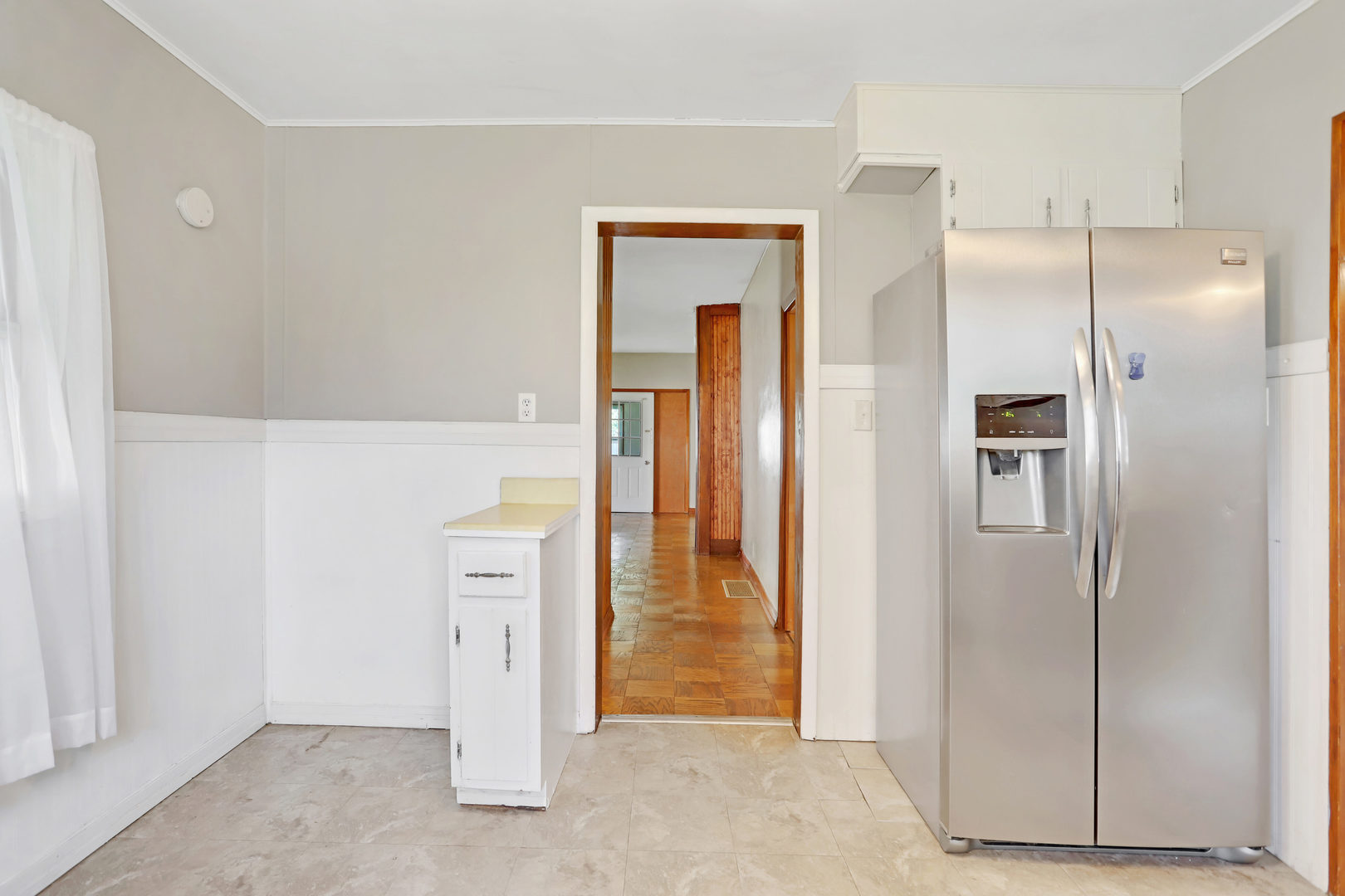812 East Webster Street Clinton, IL 61727 - Photo 14 of 26 a view of a kitchen with refrigerator and wooden floor