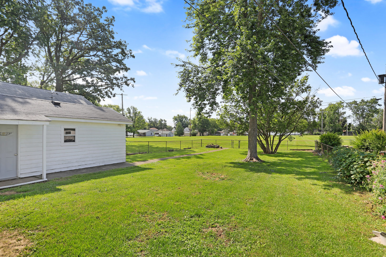 812 East Webster Street Clinton, IL 61727 - Photo 6 of 26 a view of a backyard with large trees