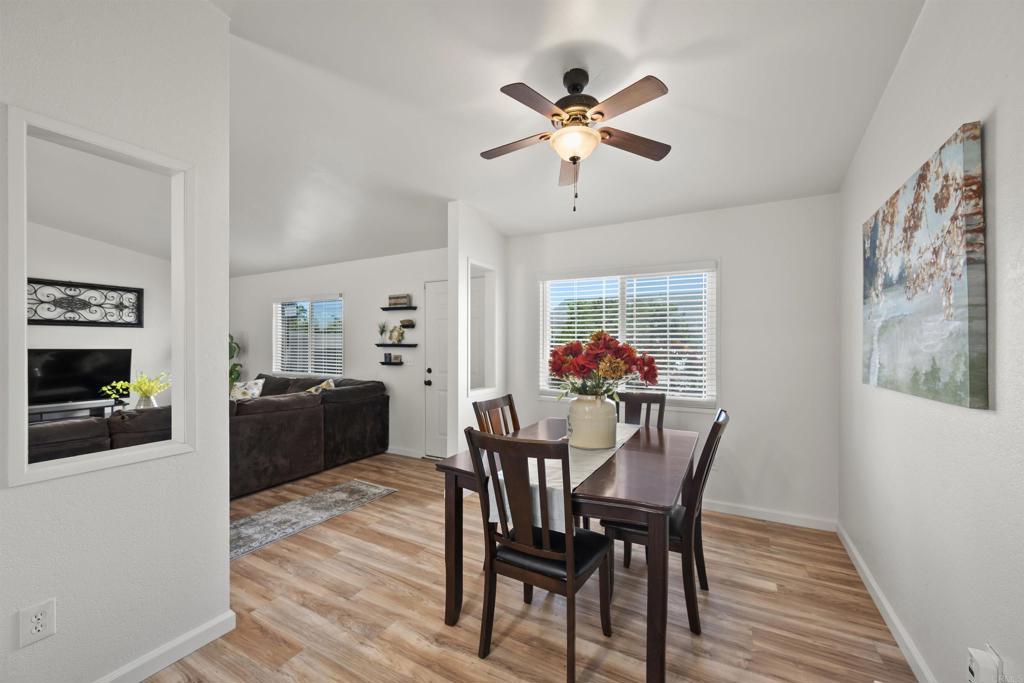 8620 Atlas View Drive Santee, CA 92071 - Photo 20 of 58 a view of a dining room with furniture a chandelier and wooden floor