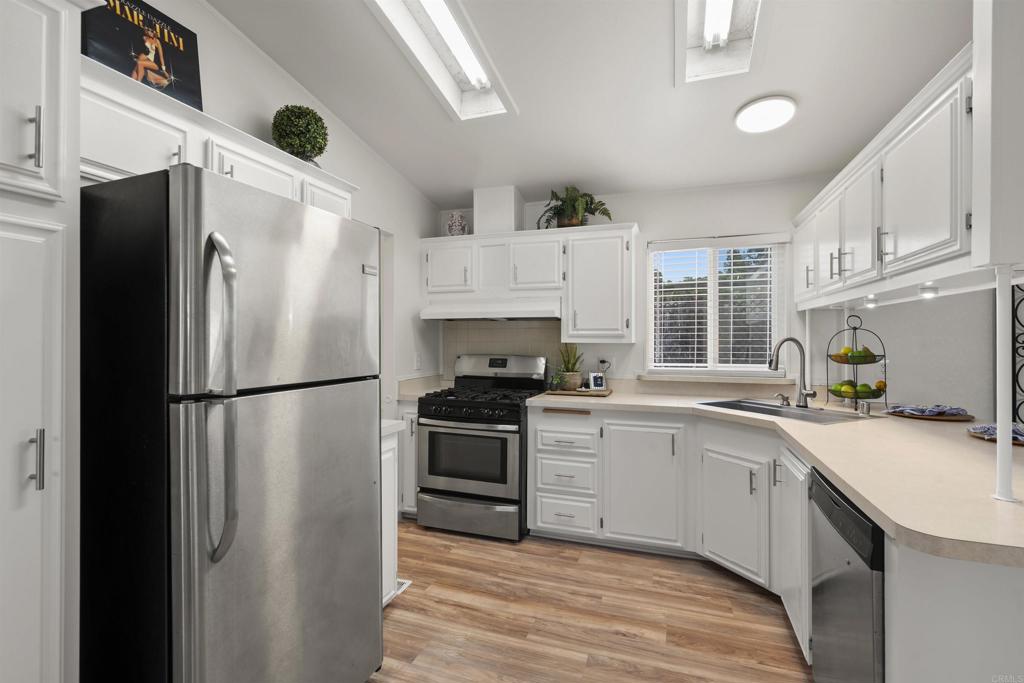 8620 Atlas View Drive Santee, CA 92071 - Photo 25 of 58 a kitchen with stainless steel appliances a refrigerator sink and stove