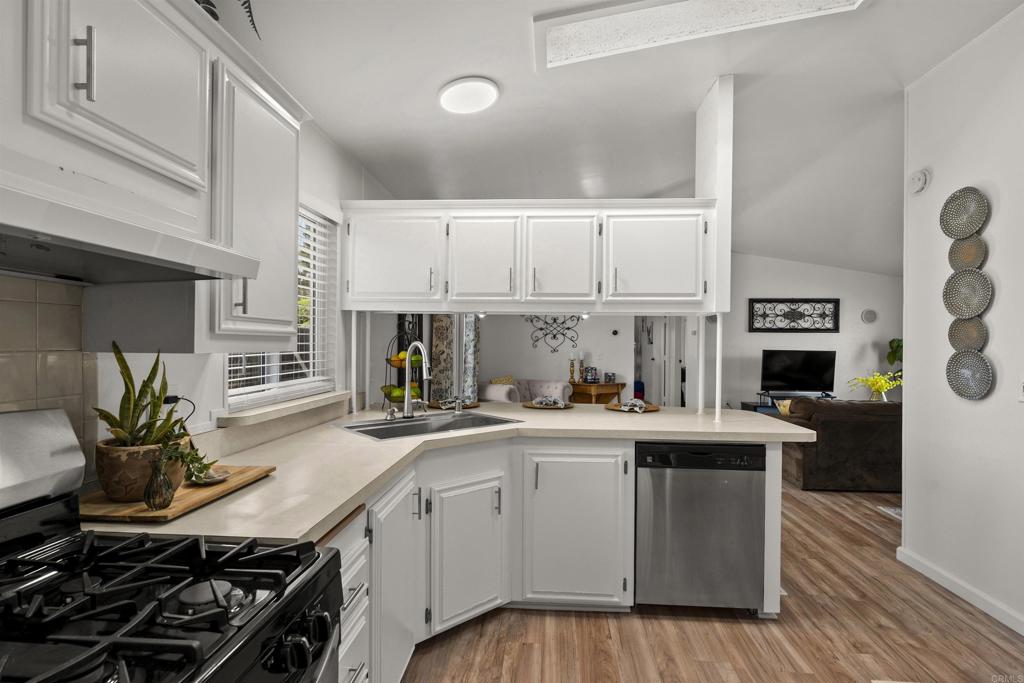 8620 Atlas View Drive Santee, CA 92071 - Photo 26 of 58 a kitchen with a sink stove and cabinets