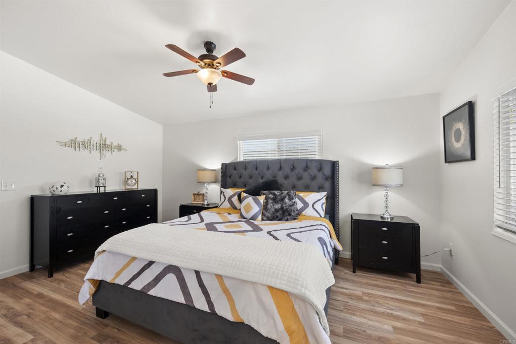 8620 Atlas View Drive Santee, CA 92071 - Photo 30 of 58 a bedroom with a bed and wooden floor