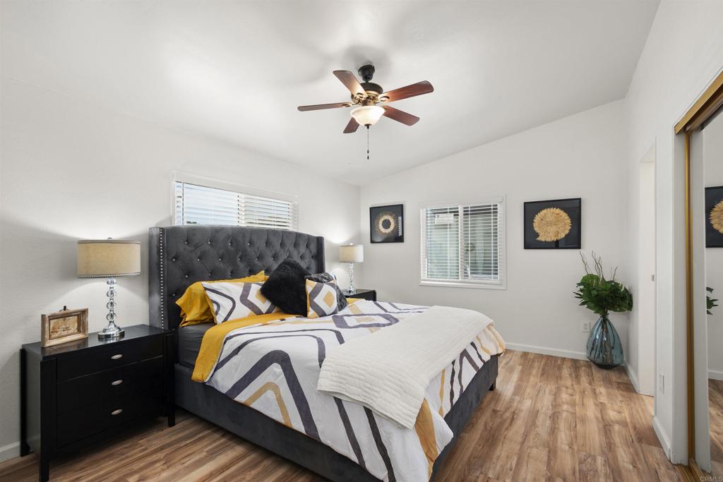 8620 Atlas View Drive Santee, CA 92071 - Photo 31 of 58 a bedroom with a bed and wooden floor