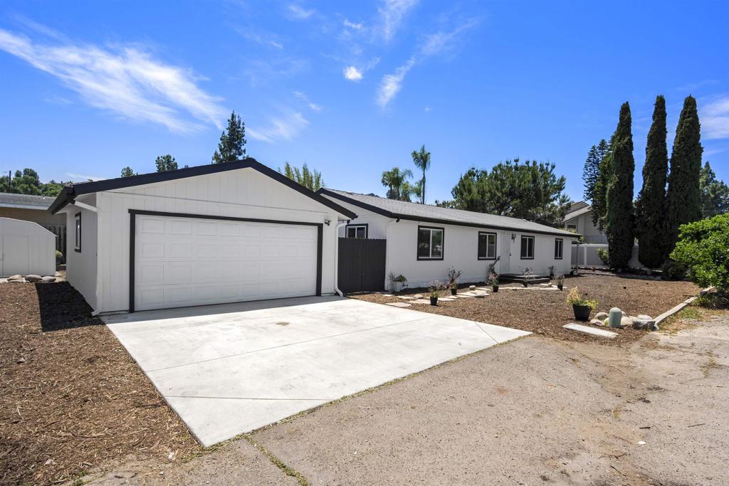 8620 Atlas View Drive Santee, CA 92071 - Photo 4 of 58 a front view of a house with a yard and garage
