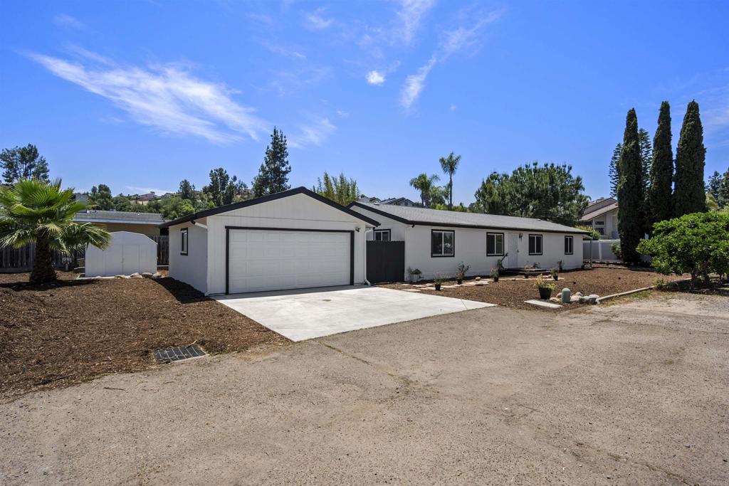 8620 Atlas View Drive Santee, CA 92071 - Photo 58 of 58 a front view of a house with a yard and garage