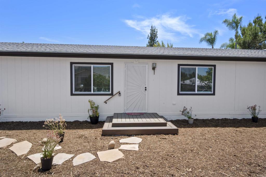 8620 Atlas View Drive Santee, CA 92071 - Photo 8 of 58 a front view of a house with a yard