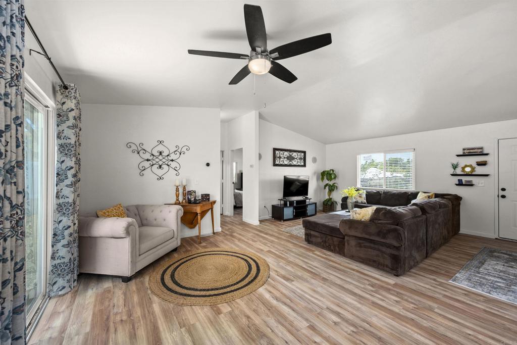 8620 Atlas View Drive Santee, CA 92071 - Photo 9 of 58 a living room with fireplace furniture and a wooden floor