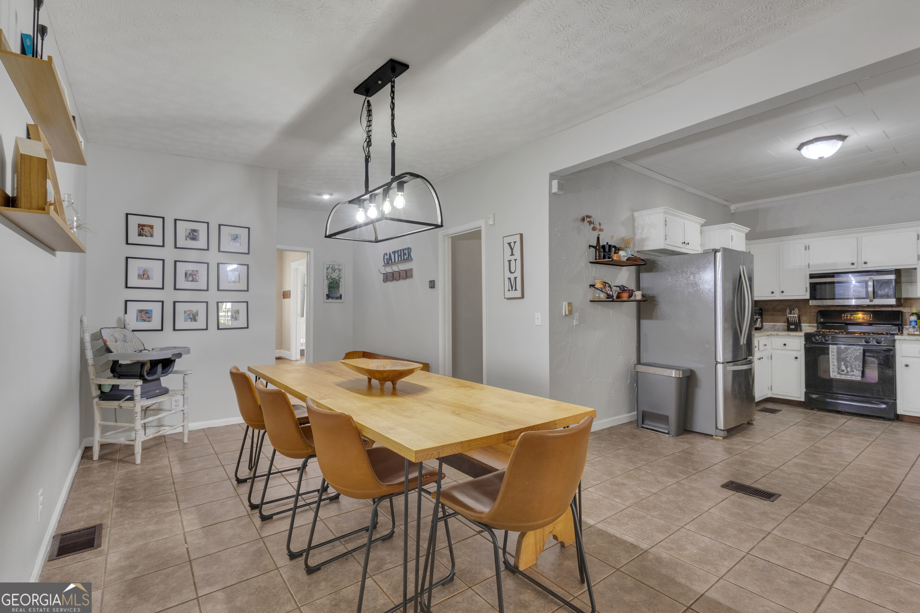 32 Post Street Grantville, GA 30220 - Photo 19 of 39 a view of a dining room and livingroom with furniture wooden floor a chandelier