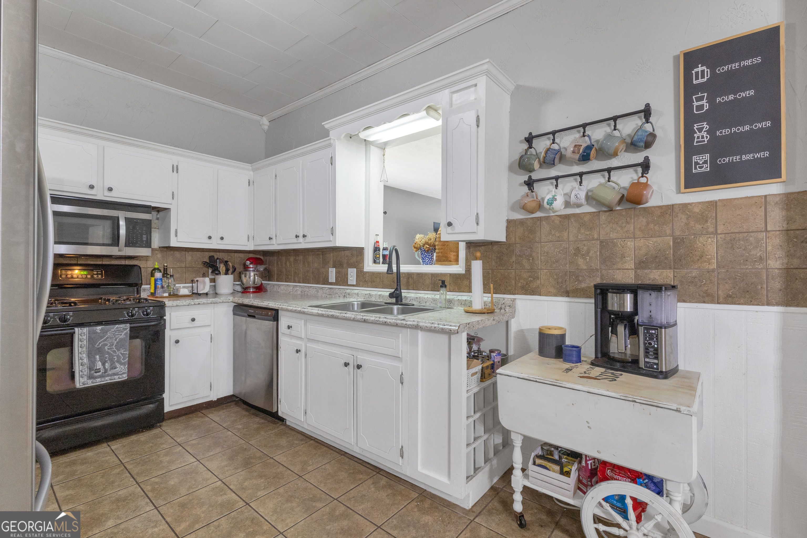 32 Post Street Grantville, GA 30220 - Photo 20 of 39 a kitchen with a sink stove and cabinets