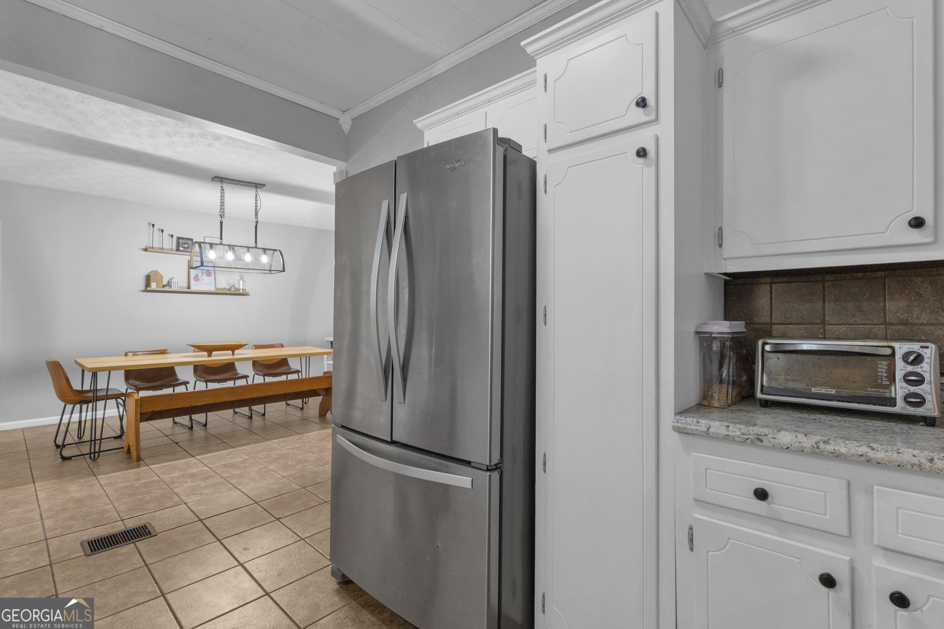 32 Post Street Grantville, GA 30220 - Photo 21 of 39 a kitchen with granite countertop a refrigerator and a stove top oven