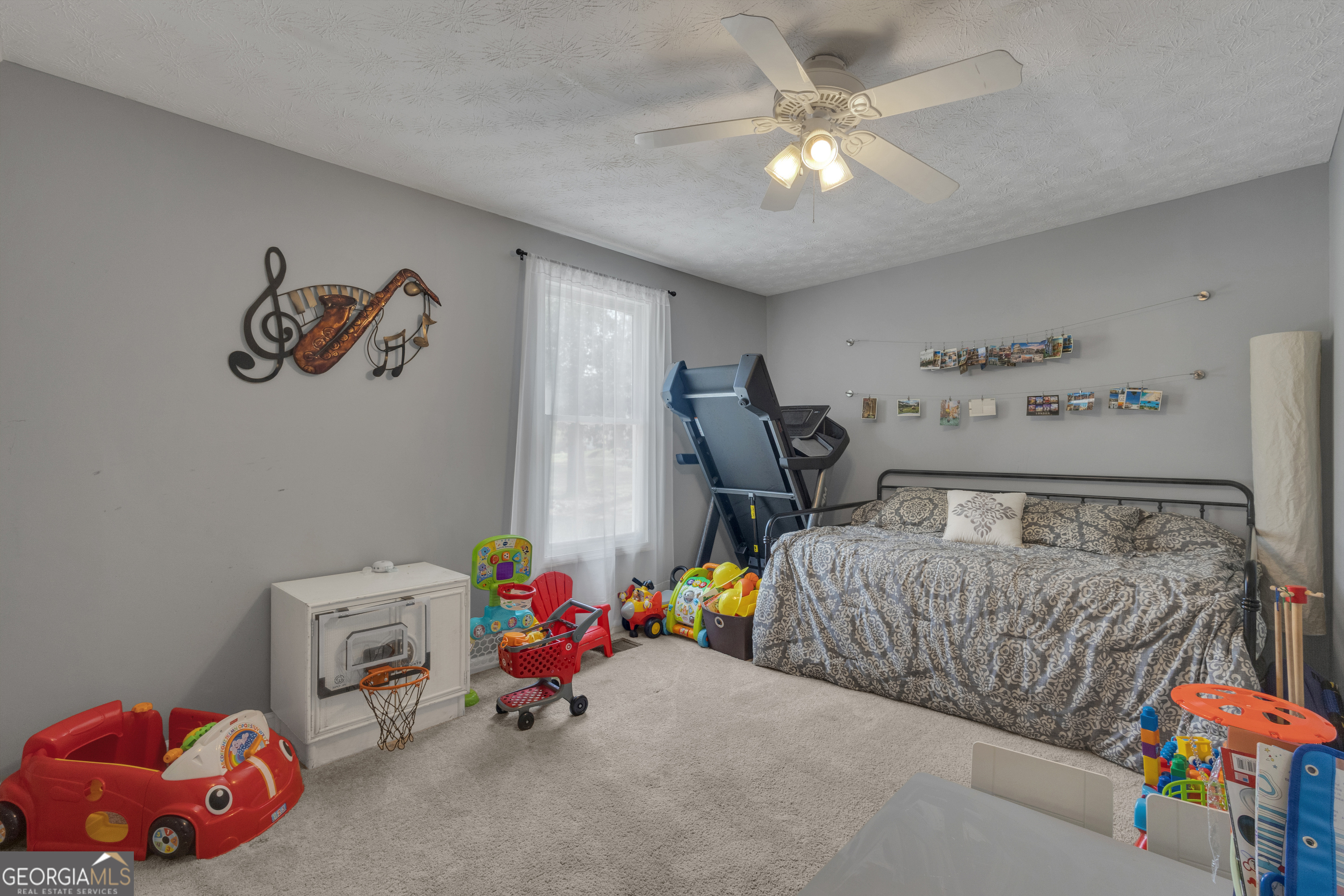 32 Post Street Grantville, GA 30220 - Photo 24 of 39 a bedroom with bed and a chandelier