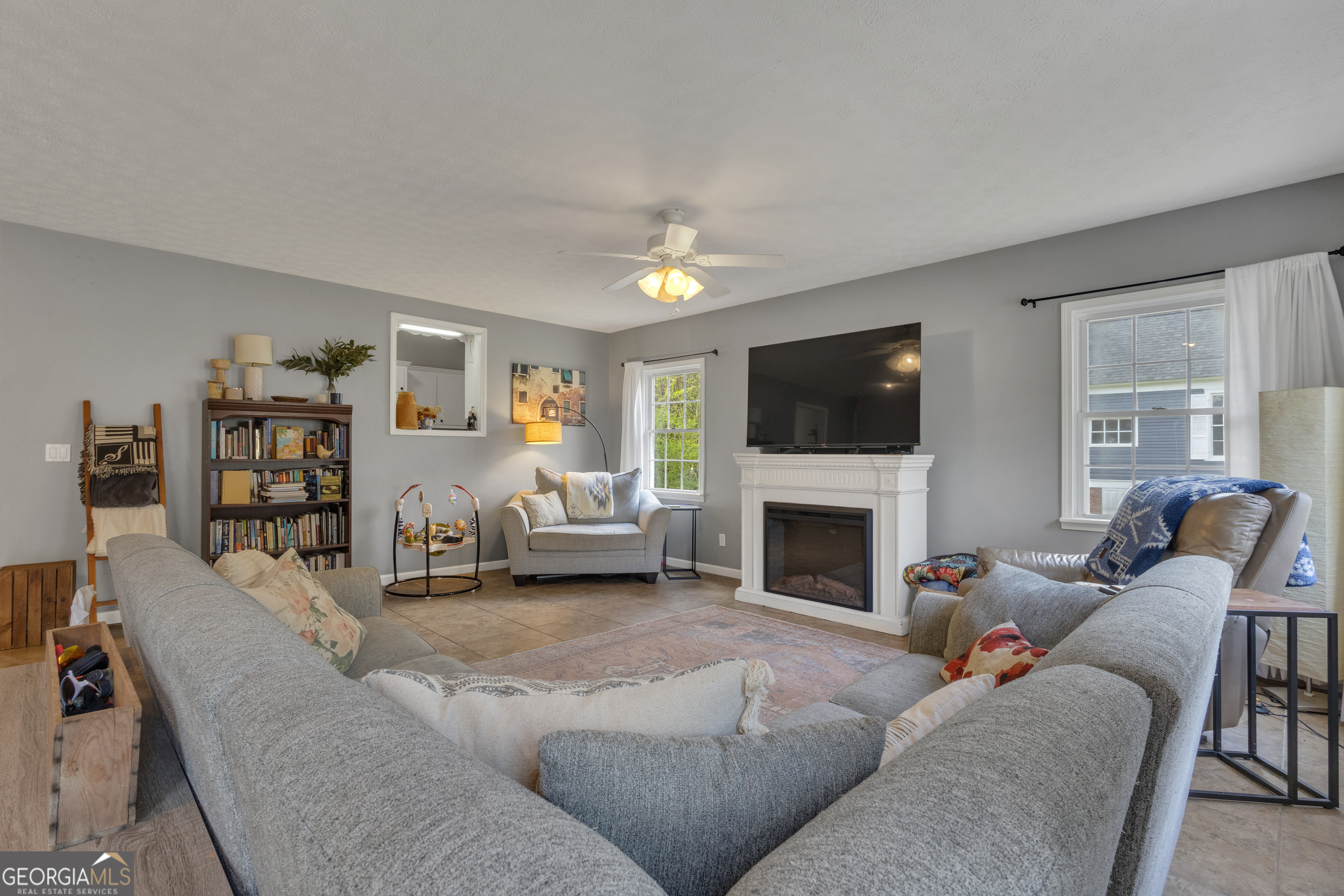 32 Post Street Grantville, GA 30220 - Photo 28 of 39 a living room with furniture a fireplace and a flat screen tv