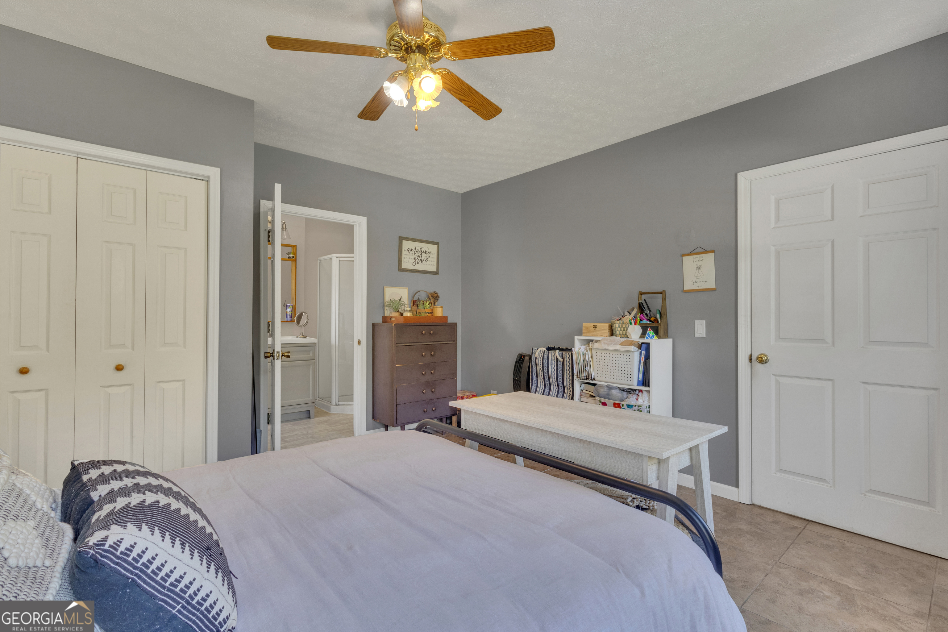 32 Post Street Grantville, GA 30220 - Photo 6 of 39 a bedroom with a bed and a chandelier