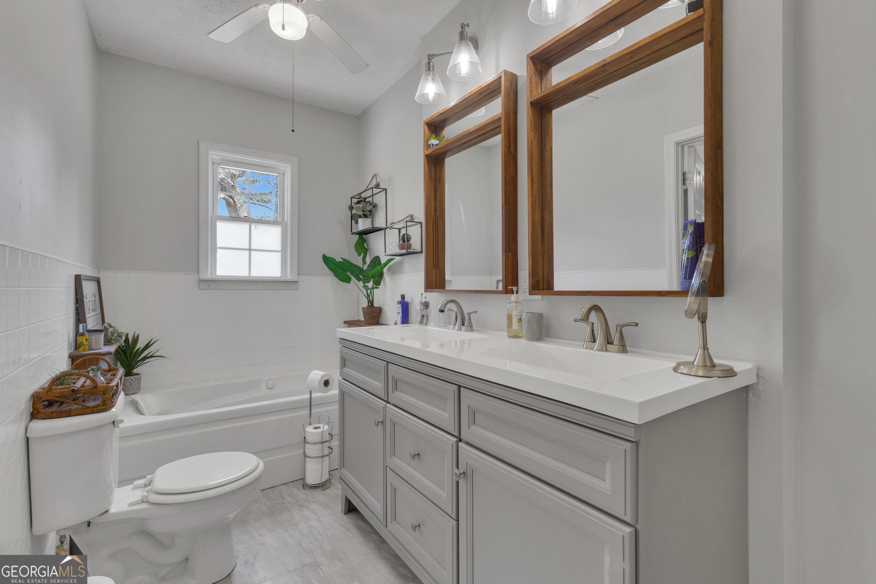 32 Post Street Grantville, GA 30220 - Photo 7 of 39 a bathroom with a toilet a sink a mirror a window and vanity