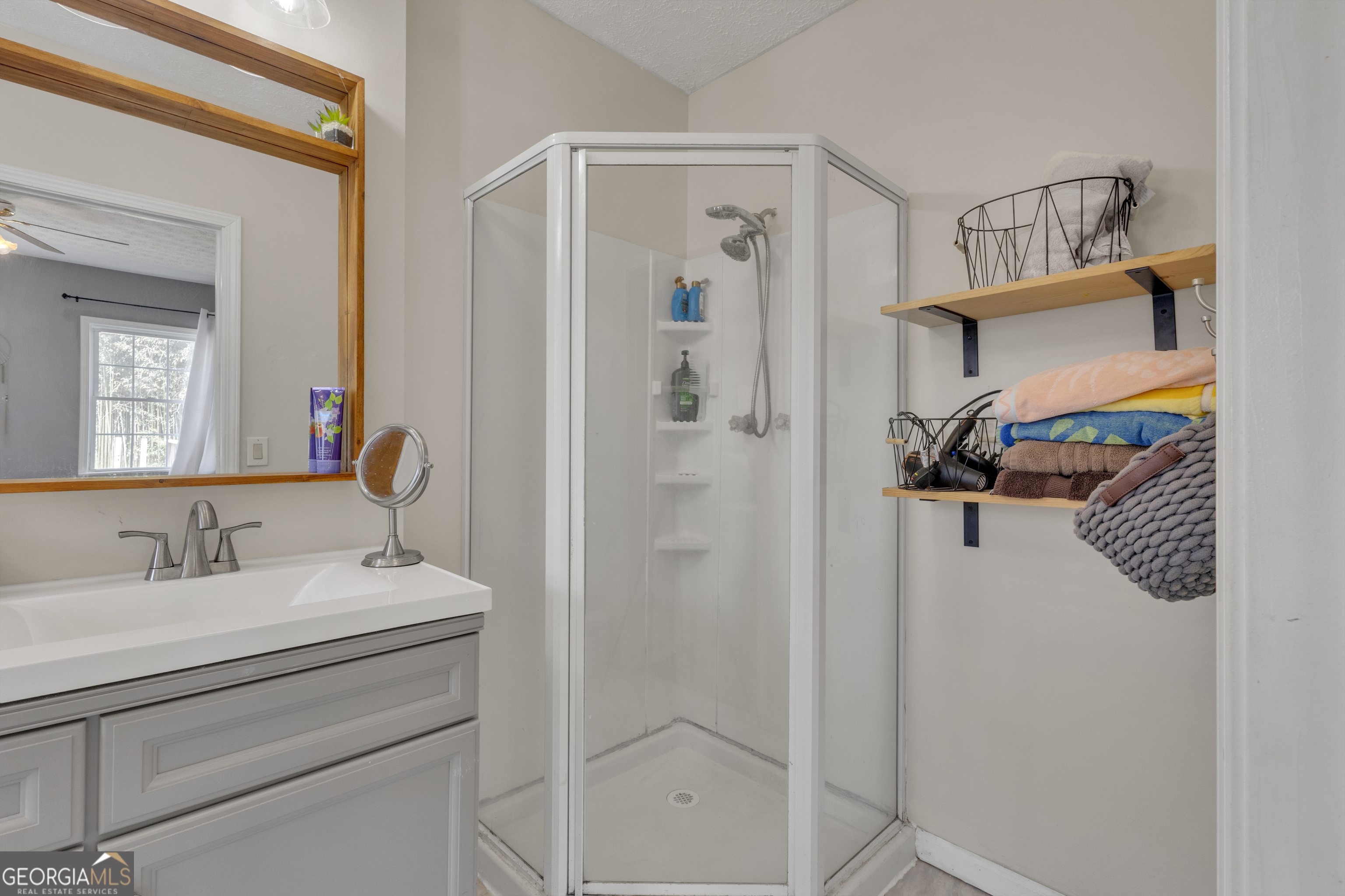 32 Post Street Grantville, GA 30220 - Photo 8 of 39 a bathroom with a shower sink vanity and mirror