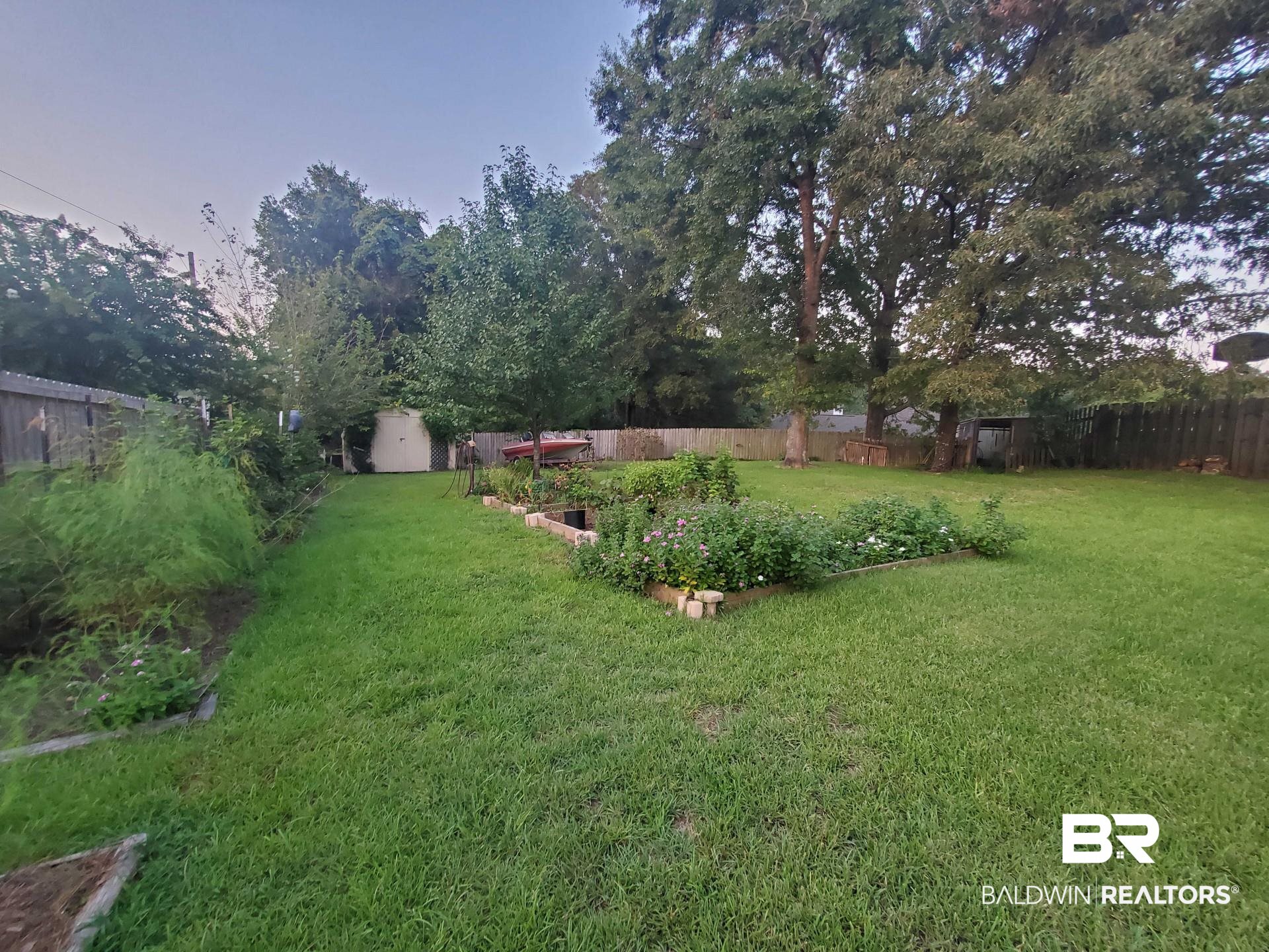 31163 Woodland Way Daphne, AL 36527 - Photo 41 of 44 Yard at dusk with a storage shed