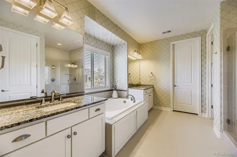 a spacious bathroom with a sink mirror and a bath tub