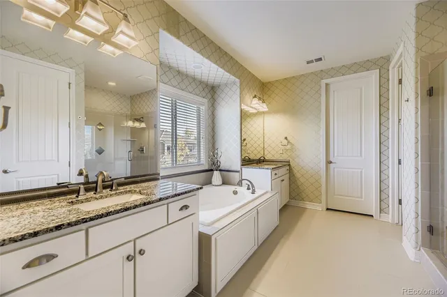 a spacious bathroom with a sink mirror and a bath tub