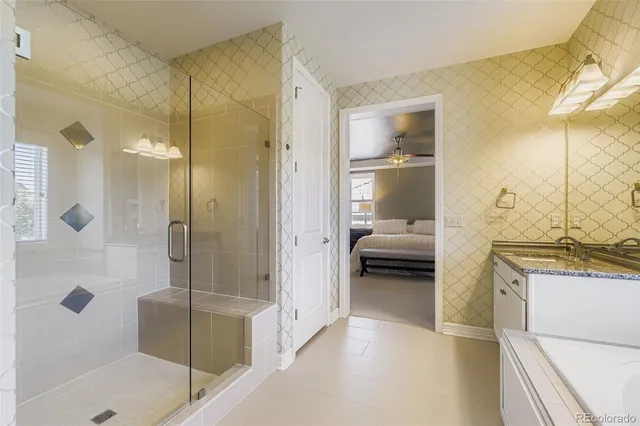 a bathroom with a tub and a glass door shower