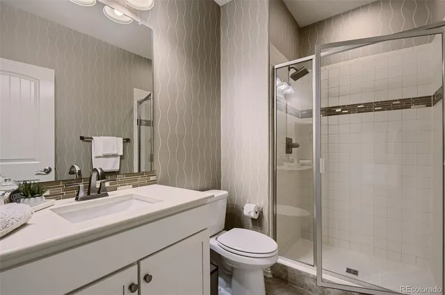 a bathroom with a sink toilet and shower