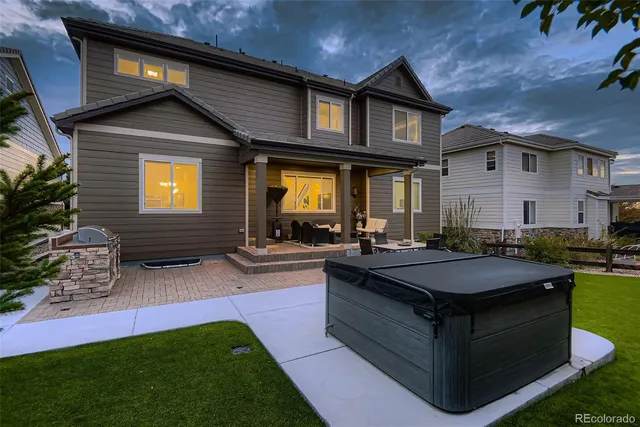a view of an house with backyard space and balcony