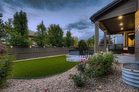 a view of a backyard with sitting area
