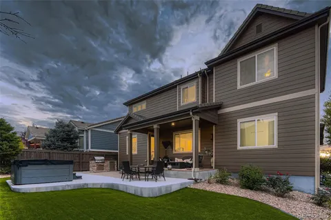 a view of a house with patio and a garden