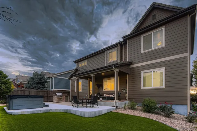 a view of a house with patio and a garden