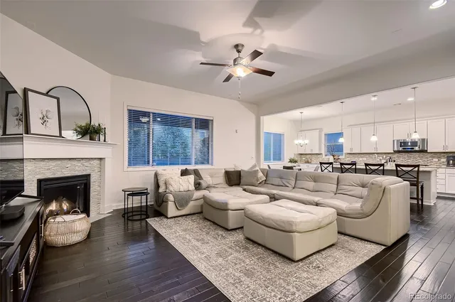a living room with furniture fireplace and window