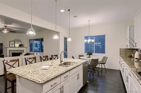 a view of a a dining table chairs and chandelier