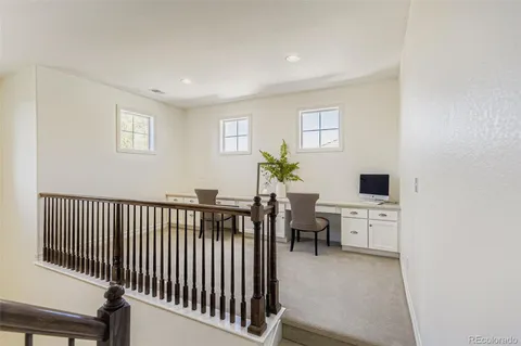 a living room with furniture a flat screen tv and a window